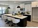 Modern kitchen with sleek black and white cabinets, stainless steel appliances, and a large center island at 1364 Barreto Dr, Wendell, NC 27591