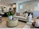 Bright living room featuring a comfortable sofa, stylish decor, and an open floor plan to the kitchen at 1364 Barreto Dr, Wendell, NC 27591