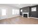 Bright living room featuring a fireplace, large windows, and modern finishes at 1364 Barreto Dr, Wendell, NC 27591