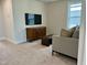 Carpeted living room featuring a tv and storage cabinet, with modern furniture at 1364 Barreto Dr, Wendell, NC 27591