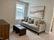 The cozy living room is staged with a sofa, plush pillows, and stylish ottoman stools at 1364 Barreto Dr, Wendell, NC 27591