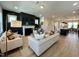 Spacious living room with fireplace flows into kitchen featuring an open floor plan and modern design at 1364 Barreto Dr, Wendell, NC 27591