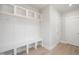Mudroom featuring a white bench with shelving and hooks, next to two white doors at 1364 Barreto Dr, Wendell, NC 27591