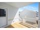 Outdoor porch with natural wood floors and white posts with an adjoining door at 1364 Barreto Dr, Wendell, NC 27591