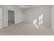 Well-lit bedroom with carpeted floor and access to hallway at 14 Baird Cv Ln, Angier, NC 27501