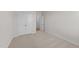 Well-lit bedroom featuring carpet, double doors, and access to hallway at 14 Baird Cv Ln, Angier, NC 27501