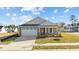 Gray Craftsman style home with white garage door and landscaping at 14 Baird Cv Ln, Angier, NC 27501