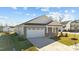 Gray Craftsman style home with white garage door and landscaping at 14 Baird Cv Ln, Angier, NC 27501