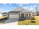 Gray Craftsman style home with white garage door and landscaping at 14 Baird Cv Ln, Angier, NC 27501