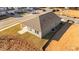 Gray house with a covered patio and grassy yard at 14 Baird Cv Ln, Angier, NC 27501