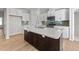 Modern kitchen with white cabinets, stainless steel appliances, and a large island at 14 Baird Cv Ln, Angier, NC 27501