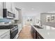 Modern kitchen with island and view into adjoining living area at 14 Baird Cv Ln, Angier, NC 27501