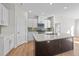 Modern kitchen with white cabinets, large island, and hexagon tile backsplash at 14 Baird Cv Ln, Angier, NC 27501
