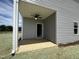 Covered back porch with a ceiling fan, concrete flooring and vinyl siding, blending outdoor comfort with modern design at 14 E American Marigold Dr # 65, Benson, NC 27504
