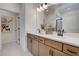 Elegant bathroom featuring double sinks, wood cabinets, and a large mirror at 14 E American Marigold Dr # 65, Benson, NC 27504