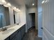 Bathroom features double sinks, a large mirror, and modern lighting fixtures at 14 E American Marigold Dr # 65, Benson, NC 27504