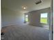 Spacious bedroom featuring neutral carpet, natural lighting, and three windows at 14 E American Marigold Dr # 65, Benson, NC 27504