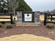 Community sign for Alder Creek neighborhood with stone accents surrounded by landscaping at 14 E American Marigold Dr # 65, Benson, NC 27504
