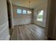 Bright dining room with wood-look floors, chandelier, wainscoting and natural light at 14 E American Marigold Dr # 65, Benson, NC 27504