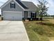 Charming single-Gathering home boasts a well-manicured lawn and attached two-car garage at 14 E American Marigold Dr # 65, Benson, NC 27504