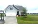 Charming single-Gathering home featuring a well-manicured lawn, attached garage, and neutral exterior at 14 E American Marigold Dr # 65, Benson, NC 27504