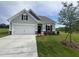 Charming one-story home with a well-manicured lawn and a two-car garage at 14 E American Marigold Dr # 65, Benson, NC 27504