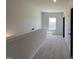 Upstairs hallway with neutral carpet, a window, and a railing at 14 E American Marigold Dr # 65, Benson, NC 27504