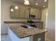 Well-lit kitchen with granite countertops, stainless steel appliances, and ample cabinet space at 14 E American Marigold Dr # 65, Benson, NC 27504