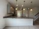 Eat-in kitchen featuring granite countertops, modern pendant lighting, and stainless steel appliances at 14 E American Marigold Dr # 65, Benson, NC 27504