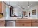 Stylish kitchen island featuring a stainless steel dishwasher and a view into the living room at 14 E American Marigold Dr # 65, Benson, NC 27504