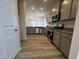 Modern kitchen with stainless steel appliances, granite countertops, and ample cabinet space at 14 E American Marigold Dr # 65, Benson, NC 27504