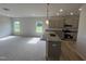 Open concept living area connected to a modern eat-in kitchen with stainless steel appliances and ample sunlight at 14 E American Marigold Dr # 65, Benson, NC 27504