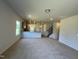Open-concept living room and kitchen featuring modern lighting and neutral color palette at 14 E American Marigold Dr # 65, Benson, NC 27504