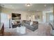 Carpeted living room features a large sectional sofa with neutral pillows and modern wall decor at 14 E American Marigold Dr # 65, Benson, NC 27504