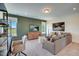 Bright living room featuring modern furniture, neutral colors, and green accent wall with media console at 14 E American Marigold Dr # 65, Benson, NC 27504