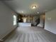 Spacious living room with neutral carpet, an open floor plan and plenty of natural light at 14 E American Marigold Dr # 65, Benson, NC 27504