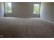 Spacious carpeted main bedroom with two windows overlooking the backyard at 14 E American Marigold Dr # 65, Benson, NC 27504