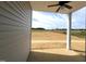 A covered patio offers a view of the expansive backyard and surrounding farmland at 14 E American Marigold Dr # 65, Benson, NC 27504