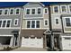 Modern 3-story townhome with attached garage and brick accents at 2107 Lambert Rd # 64, Cary, NC 27519