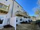 Rear view of townhouses with balconies, fences, and landscaping at 2107 Lambert Rd # 64, Cary, NC 27519