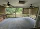 An empty screened-in back porch features twin ceiling fans and a view of the backyard at 216 Parrish Farm Lane Ln, Benson, NC 27504