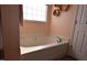 Bathroom featuring a large soaking tub and a window at 216 Parrish Farm Lane Ln, Benson, NC 27504