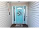 Charming turquoise front door with decorative wreath, sidelights and welcome mat, creating a warm and inviting entrance to the home at 216 Parrish Farm Lane Ln, Benson, NC 27504