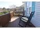Inviting front porch with classic rocking chairs, offering a cozy outdoor space for relaxation with a glimpse of the neighborhood at 216 Parrish Farm Lane Ln, Benson, NC 27504