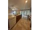 Island kitchen with a view of the living room, featuring tile flooring, an island sink, and appliances at 216 Parrish Farm Lane Ln, Benson, NC 27504