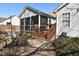 View of screened porch with a step-down exit, cozy sitting area and serene backyard views at 216 Parrish Farm Lane Ln, Benson, NC 27504