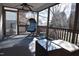 Cozy screened-in porch featuring a hanging chair and comfortable seating, perfect for relaxing with a view of the outdoors at 216 Parrish Farm Lane Ln, Benson, NC 27504