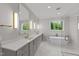 Luxurious bathroom with double vanity, soaking tub, and glass shower at 2404 Toll Mill Ct, Raleigh, NC 27606