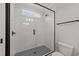 Modern bathroom with a glass shower door and gray tile at 2404 Toll Mill Ct, Raleigh, NC 27606