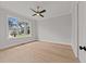 Spacious bedroom with hardwood floors and large window at 2404 Toll Mill Ct, Raleigh, NC 27606